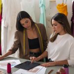 2 women working as clothing designers